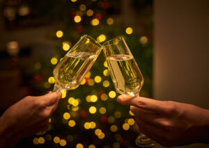 Two glasses of champagne with fairy lights